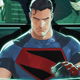 Superman, wearing a t-shirt with his S-shield on black, stares intently at a computer screen.